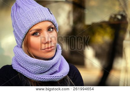 The Concept Of Livestyle  Outdoor In Autumn. Close Up Of A Young Woman Student In A Warm Autumn Clot