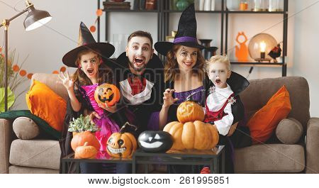 Happy Family Mother Father And Children In Costumes And Makeup On A Celebration Of Halloween