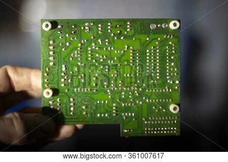 Board From A Computer Device. Microcircuit For The Operation Of Technology. Pcb Repair. Solder Case.