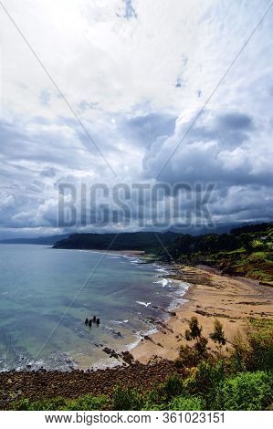 Picturesque Landscape Of Playa De Lastres Against Dramatic Sky In Summer Day. Asturias, Spain