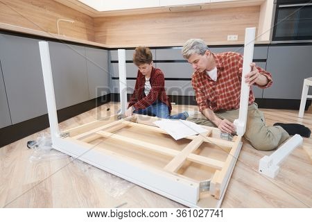 father and son work together. kitchen furniture assembling