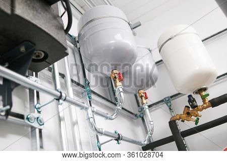 Plumbing service. stainless steel pipeline and expansion vessel of a heating system in boiler room