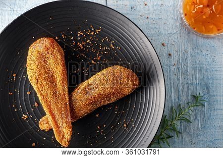 Seasoned Chicken With Hot Sauce And A Sprig Of Rosemary
