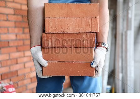 Gloved Builder Manually Carries Brick Construction. Building Bricks Are Used For Exterior And Interi