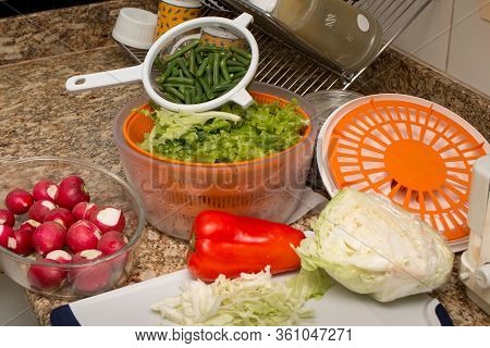 Ingredients For Preparing A Delicious Fresh Salad In The Kitchen