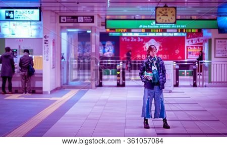 A Woman Is Standing In Front Of Entrance Of Sendai Jr Station.
