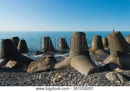 Tetrapod Breakwaters On The Coast. Concrete Breakwaters Of Tetrapods Lie All Along The Coast.