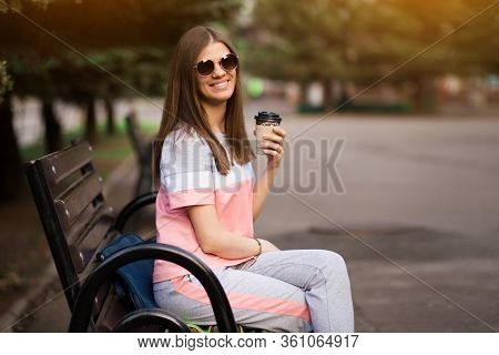 Git In Sunglasses Sit On Bench And Drink Coffee