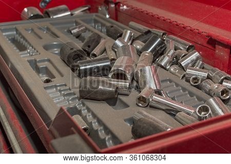 A Mechanic's Unorganized Tray Of Sockets In A Red Tool Cabinet.