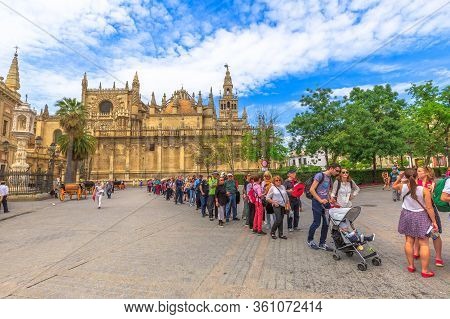 Seville, Andalusia, Spain - April 19, 2016: Row Of Tourists To Visit The Royal Alcazar Of Seville In