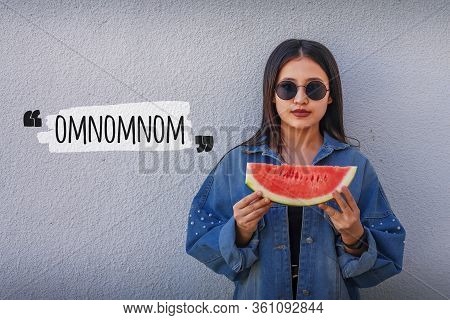 Portrait Of A Beautiful Young Lady Eating Watermelon At Outdoors. A Little Girl In Trendy Denim Hold