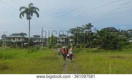Lago Agrio, Sucumbios / Ecuador - February 20 2020: Group Of Tourists Walking Along A Path Towards T