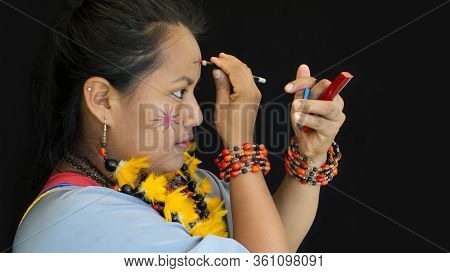 Lago Agrio, Sucumbios / Ecuador - February 20 2020: Woman Of The Cofan Ethnic Group Applying Makeup 