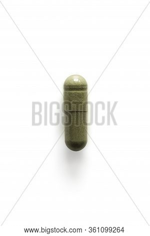 Andrographis Paniculata Pill Capsule In Green On White Background With Clipping Path And Copy Space.