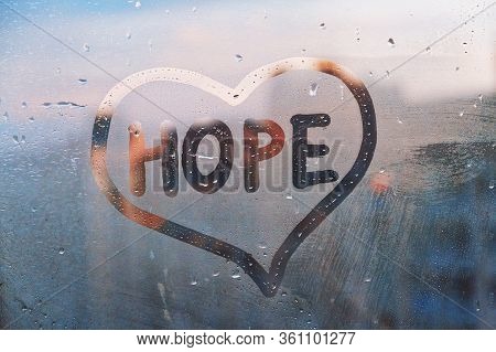 Foggy Glass On Window With Written Finger Word Yellow Color Hope In Paint Heart Concept Photo With C