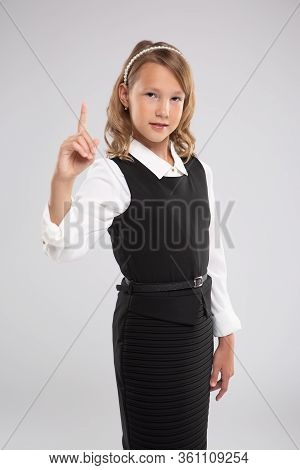 Beautiful Schoolgirl Shows A Sign-attention! Portrait On Isolated Background