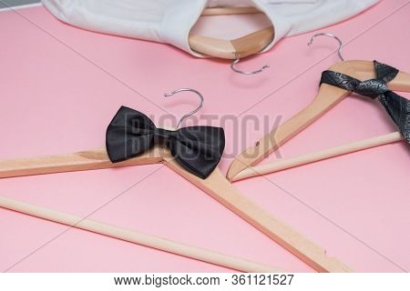 Bow Tie And Shirt On Hanger And Empty Wooden Hangers O