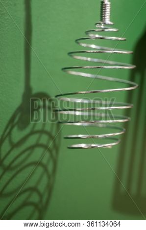 Different Kitchen Tools For Cooking Hanging On The Wall