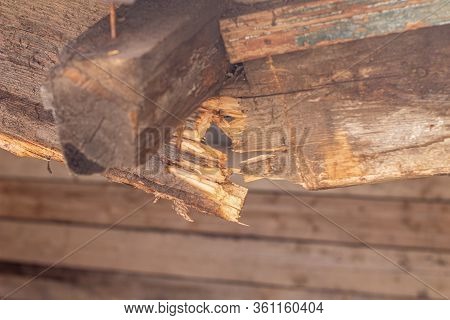 Broken Wooden Beam Of The Canopy. Wooden Roof Of A Barn Destroyed Due To The Weather