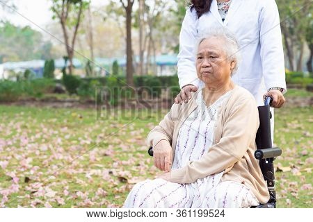 Doctor Help And Care Asian Senior Or Elderly Old Lady Woman Patient Sitting On Wheelchair At Park In