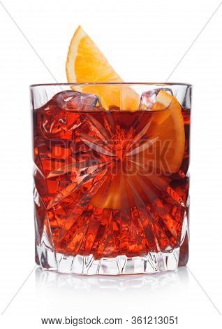 Negroni Cocktail In Crystal Glass With Ice Cubes And Orange Slice On White Background