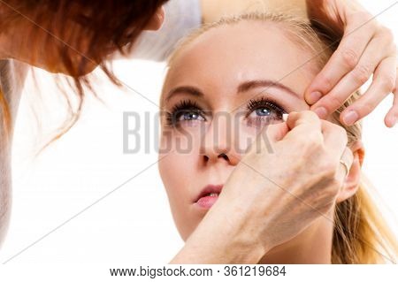 Two Women, Face Painting. Makeup Artist Applying Make Up To Model Face. Cosmetic Beauty Procedures, 