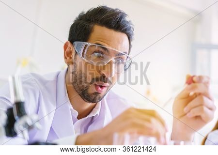 Doctor And Microbiologist With Vacuum Tubes For Samples With Covid 19 Infection Atypical Pneumonia V