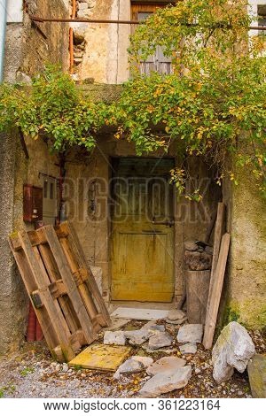 An Old Wooden Door In A Derelict Building In The Historic Hill Village Of Stanjel In The Komen Munic