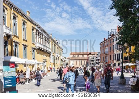 Venice, Italy - September 28, 2015 : Streets Of Venice City. Woman In Blue Jacket Is Standing On A P