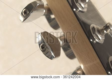 Pegs On An Electric Guitar. Hold And Tune The Strings. Slight Gloss From Reflection. Light Blurred B