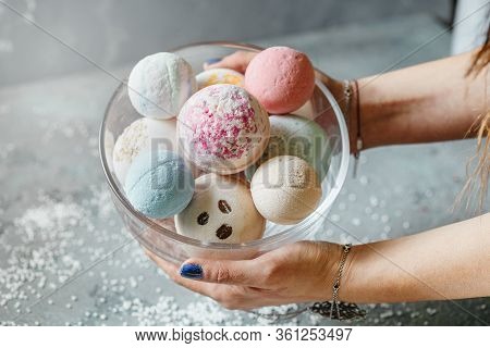 Female Hands On A Light Background Hold A Bowl Full Of Multi-colored Balls For A Bath, Handmade. Pre