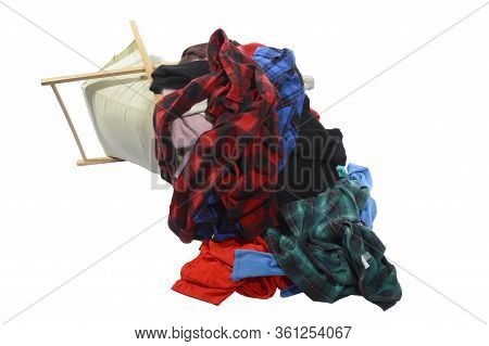 Horizontal Shot Of An Overstuffed Laundry Basket That Fell Over.  Shot On An Angle.  White Backgroun