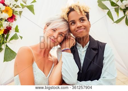 African American Female Groom In Black Suit And Caucasian Bride In Dress In Ceremony On Tropical Bea