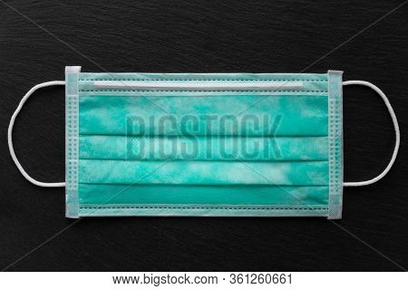 Facial Medical Maska For Virus Protection On A Black Textured Background