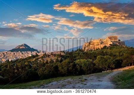Famous greek tourist landmark - the iconic Parthenon Temple at the Acropolis of Athens as seen from Philopappos Hill on sunset. Athens, Greece