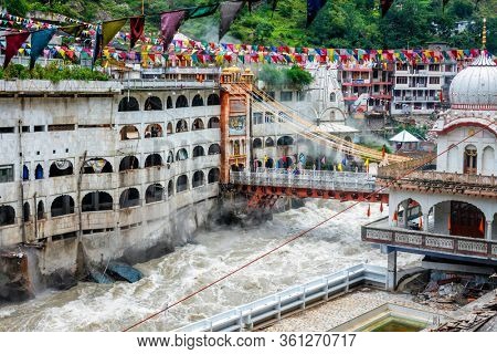 Sikh Gurdwara, bridge over Parvati river and hot springs in Manikaran Sikh sacred site in Himalayas. Himachal Pradesh, India
