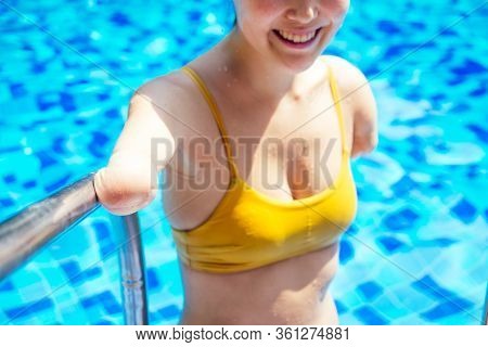Happy Asian Armless Woman Warming Up Before Swimming At The Tropical Beach, She Jumps