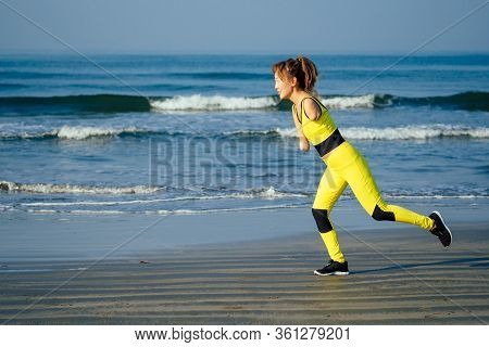 Happy Asian Armless Woman Warming Up Before Swimming At The Tropical Beach