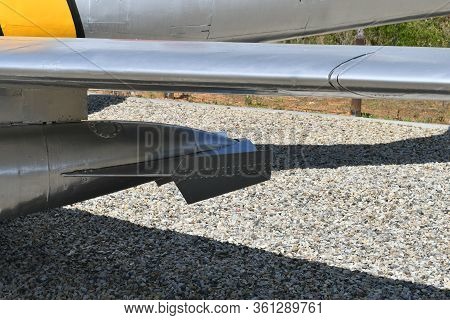 Rear Section Of External Fuel Tank Mounted Under Wing Of Fighter Jet On Display At Public Park.