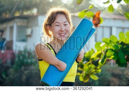 Happy Asian Armless Woman Warming Up Before Swimming At The Tropical Beach