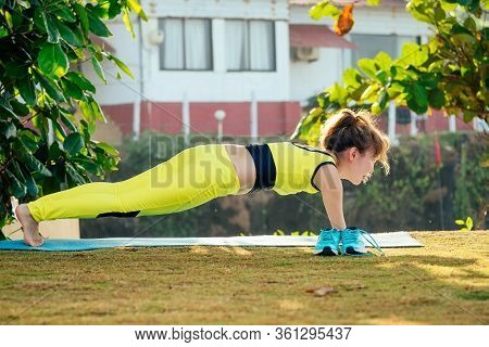Happy Asian Armless Woman Warming Up Before Swimming At The Tropical Beach