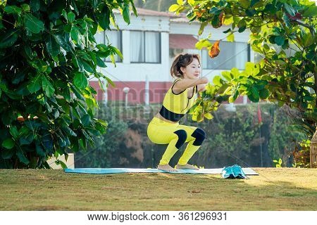 Happy Asian Armless Woman Warming Up Before Swimming At The Tropical Beach