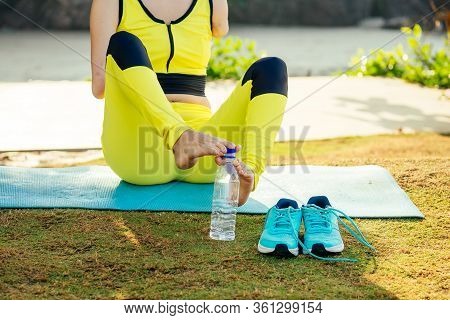 Happy Asian Armless Woman Warming Up Before Swimming At The Tropical Beach, She Drinking Water