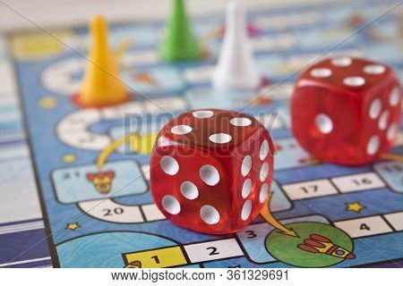Multi-colored Game Chips With Dice On The Playing Board. Concept Of Leisure Games