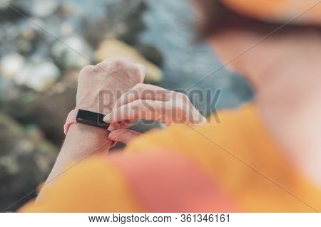 Woman Hiker Using Smart Bracelet During Trekking In Nature. Close Up Of Female Hands With Portable I