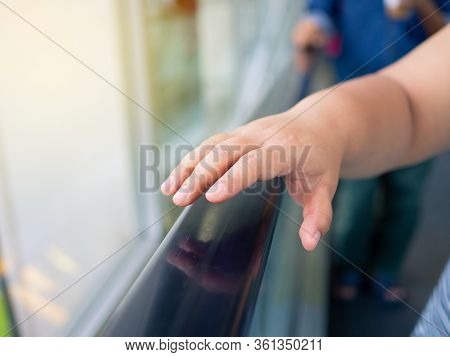 The Woman's Hand Reaches For A Public Metal Railing That May Be Infected By Viruses And Bacteria.