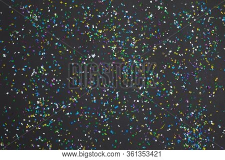 Small Color Microplastics And Plastic Parts Background On Black Background. Microplastic Problem. To