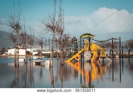 Playground For Kids In Water With Reflection After Storm That Caused Flooding. Natural Disaster Conc