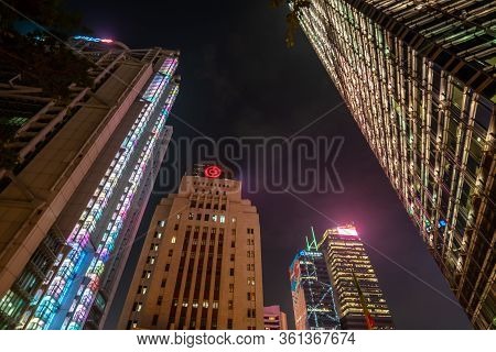 Hong Kong, China - 2020: City At Night, Skyscrapers In Night Illumination. Hsbc Main Building, Bank 