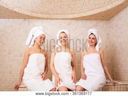 Three Girlfriends Sitting In A Hammam. Oriental Baths, Woman Relax In A Hammam